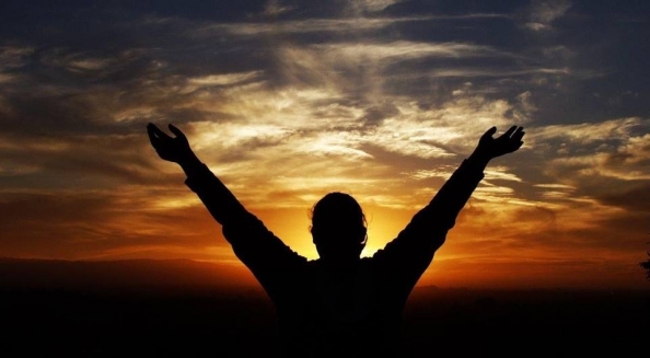 Someone celebrating the new year with their hands in the air.